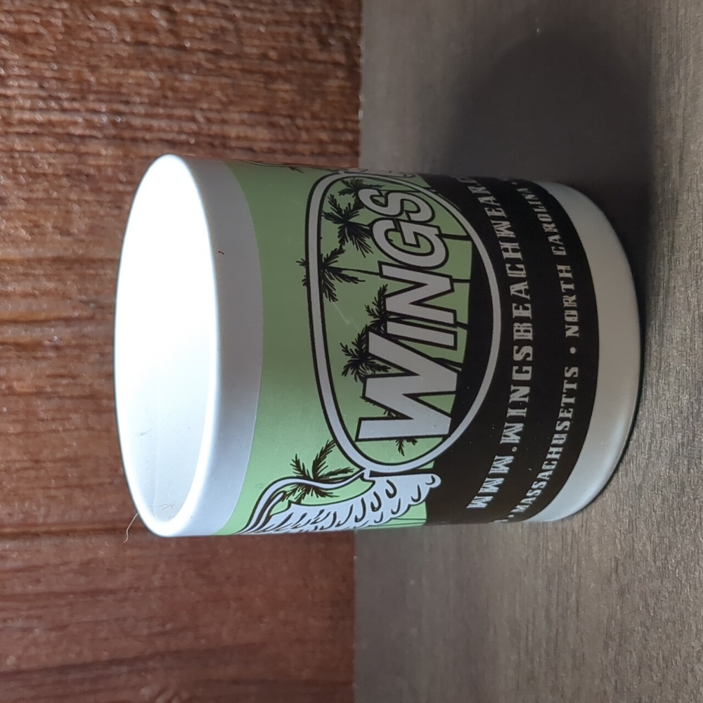 Wings Beachwear advertising coffee mug green brown